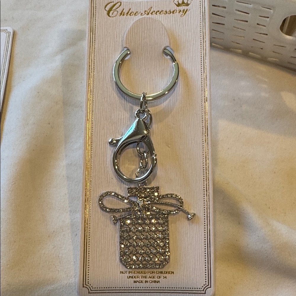 BAG CHARM Silver Tone Glittering Perfume Bottle With Bow Keychain